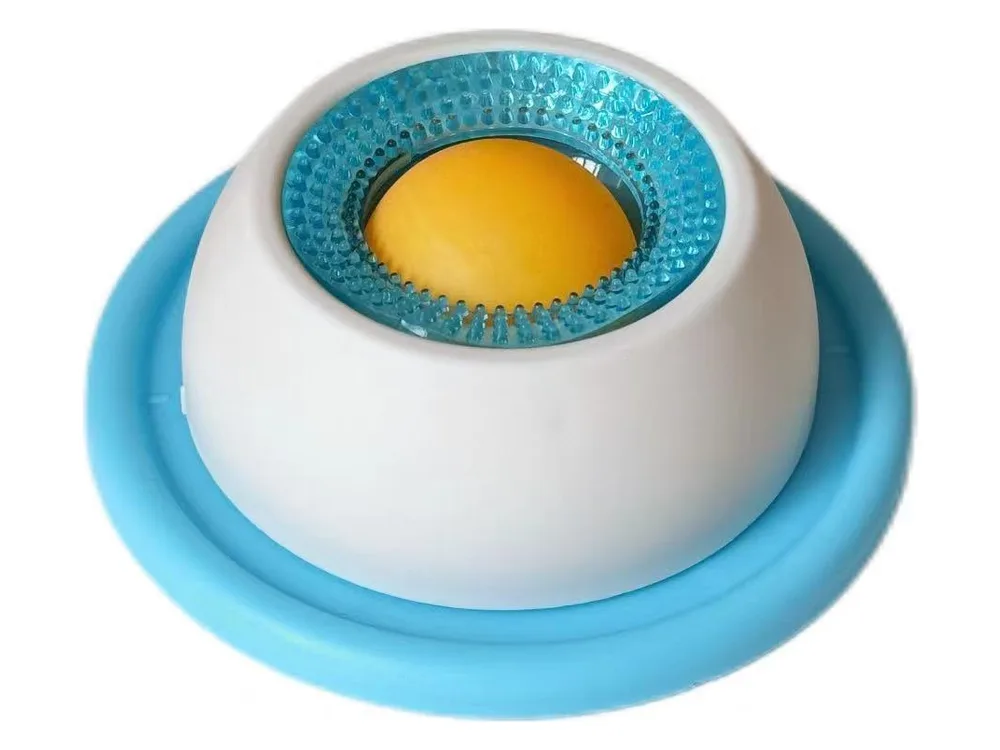 Lick bowl with a light blue base, white body and an orange rolling ball on top.