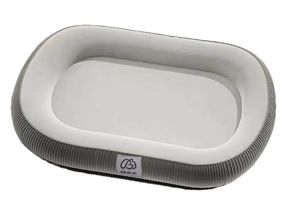 Oval dog bed with a light grey cushion and a ribbed dark grey rim.